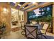 Inviting covered patio with ceiling fan, dining set, and view of the dining room at 8370 Plum Creek Ct, Las Vegas, NV 89113