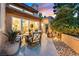 Inviting outdoor patio featuring a dining set, stone accents, and lush landscaping, perfect for relaxing and entertaining at 8370 Plum Creek Ct, Las Vegas, NV 89113