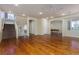 Large living room with hardwood floors, stairs to the second floor, and an open floor plan to a billiards room at 8467 Bismark Sapphire St, Las Vegas, NV 89139