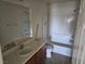 Functional bathroom with a tub, tiled walls, and vanity with sink at 8865 Knickknack Ct, Las Vegas, NV 89149
