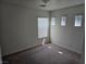 Neutral carpeted bedroom with three sunlit windows at 8865 Knickknack Ct, Las Vegas, NV 89149