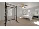 Bright bedroom featuring a weight rack, ceiling fan and carpeted floor at 9053 Starling Wing Pl, Las Vegas, NV 89143