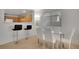 Cozy dining area with bar seating and a glass table next to the kitchen at 9053 Starling Wing Pl, Las Vegas, NV 89143