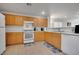 Functional kitchen featuring light wood cabinets and standard appliances at 9053 Starling Wing Pl, Las Vegas, NV 89143