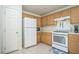 Efficient kitchen with white appliances, bright cabinets, and tile flooring at 9053 Starling Wing Pl, Las Vegas, NV 89143