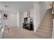 Bright living room featuring a carpeted floor, a staircase, and neutral walls at 9053 Starling Wing Pl, Las Vegas, NV 89143