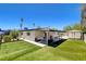 The spacious backyard features a lush lawn, mature trees, and ample space for outdoor activities at 925 Alan Shepard St, Las Vegas, NV 89145