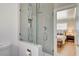 Modern bathroom features a glass shower with decorative tile, toilet, and bedroom view, creating a spa-like experience at 925 Alan Shepard St, Las Vegas, NV 89145