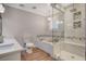 Luxurious bathroom featuring a glass-enclosed shower, soaking tub, and double vanity at 925 Alan Shepard St, Las Vegas, NV 89145