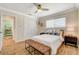 Cozy bedroom featuring ceiling fan, hardwood flooring, and comfortable furnishings at 925 Alan Shepard St, Las Vegas, NV 89145