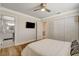 This bright bedroom features wood floors, a ceiling fan, and an attached bathroom with a modern vanity and a tiled shower at 925 Alan Shepard St, Las Vegas, NV 89145