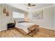 Serene bedroom with a ceiling fan, bright window, and hardwood flooring at 925 Alan Shepard St, Las Vegas, NV 89145