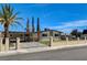 Attractive home exterior with manicured lawn, secure fencing, and convenient covered parking at 925 Alan Shepard St, Las Vegas, NV 89145