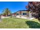 Charming home featuring a well-manicured lawn, mature tree, and a brick-accented facade at 925 Alan Shepard St, Las Vegas, NV 89145