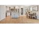 Bright kitchen featuring white cabinets, stainless steel appliances, and an island with seating at 925 Alan Shepard St, Las Vegas, NV 89145