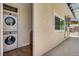 A laundry room with stacked washer and dryer inside a patio, offers added convenience at 925 Alan Shepard St, Las Vegas, NV 89145