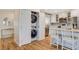 Efficient laundry area featuring a stacked washer and dryer, conveniently located near the kitchen at 925 Alan Shepard St, Las Vegas, NV 89145