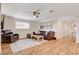 Bright living room with hardwood floors, comfortable seating, ceiling fan and modern artwork at 925 Alan Shepard St, Las Vegas, NV 89145