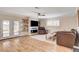 Comfortable living room with fireplace, floating shelves, ceiling fan and glass doors to backyard at 925 Alan Shepard St, Las Vegas, NV 89145