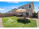 An expansive backyard is ready for entertaining with a barbecue, hot tub, and outdoor seating at 9730 Cluny Ave, Las Vegas, NV 89178