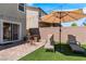 Cozy backyard patio area complete with outdoor seating, a lounge chair, and a sun umbrella at 9730 Cluny Ave, Las Vegas, NV 89178