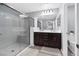 This primary bathroom offers double sinks, a large mirror, and a glass walk-in shower at 9730 Cluny Ave, Las Vegas, NV 89178