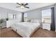 This spacious bedroom features a ceiling fan, carpeted floors, and lots of natural light from the windows at 9730 Cluny Ave, Las Vegas, NV 89178