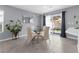 Cozy dining area with a glass table, stylish chairs, and sliding glass doors to the backyard at 9730 Cluny Ave, Las Vegas, NV 89178