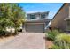Charming two-story home with a brick driveway and attached two-car garage at 9730 Cluny Ave, Las Vegas, NV 89178