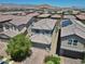 A two-story home featuring a well-kept lawn, an attached garage, and lovely neighborhood views at 9730 Cluny Ave, Las Vegas, NV 89178