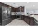 Stylish kitchen with dark cabinets, stainless steel appliances, and an open layout at 9730 Cluny Ave, Las Vegas, NV 89178
