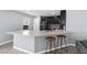 Modern kitchen featuring a breakfast bar with stools and sleek countertops at 9730 Cluny Ave, Las Vegas, NV 89178