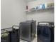 This modern laundry room has newer machines, plus storage racks, and tiled floors at 9730 Cluny Ave, Las Vegas, NV 89178