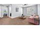 This spacious living room has a ceiling fan, carpeted floors, and views into other rooms at 9730 Cluny Ave, Las Vegas, NV 89178