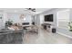Open concept living room with a large sofa, tile floors and modern decor at 9730 Cluny Ave, Las Vegas, NV 89178
