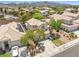 Aerial view showcasing a home with a large driveway and mature trees in a residential neighborhood at 981 Leadville Meadows Dr, Henderson, NV 89052