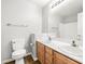 Well-lit bathroom with double sinks and a large mirror over wood cabinets at 981 Leadville Meadows Dr, Henderson, NV 89052