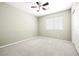 Comfortable bedroom features neutral carpet, a ceiling fan, and natural light at 981 Leadville Meadows Dr, Henderson, NV 89052
