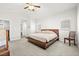 Bright bedroom with a large bed, light gray walls, and an adjacent bathroom at 981 Leadville Meadows Dr, Henderson, NV 89052