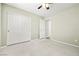 Bedroom with plush carpet, a ceiling fan, and a closet for storage solutions at 981 Leadville Meadows Dr, Henderson, NV 89052