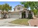 Charming two-story home featuring a well-maintained lawn and two-car garage at 981 Leadville Meadows Dr, Henderson, NV 89052