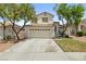 Charming two-story home with a well-maintained lawn and a spacious two-car garage at 981 Leadville Meadows Dr, Henderson, NV 89052