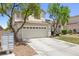 Inviting home featuring a two-car garage, mature trees and a well-manicured front lawn at 981 Leadville Meadows Dr, Henderson, NV 89052