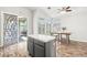 Sunlit eat-in kitchen with an island, wood floors, and sliding glass door access to the backyard at 981 Leadville Meadows Dr, Henderson, NV 89052