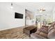 Bright living room featuring wood floors, a ceiling fan, and a staircase at 981 Leadville Meadows Dr, Henderson, NV 89052