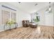 Bright living area featuring wood floors, large windows, and a comfortable couch at 981 Leadville Meadows Dr, Henderson, NV 89052