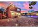 Expansive backyard with a brick patio, lush landscaping, and a sparkling pool at 9906 Stiges St, Las Vegas, NV 89178