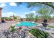 Beautiful backyard with a private pool, shaded lounge area, and meticulously landscaped grounds at 9906 Stiges St, Las Vegas, NV 89178