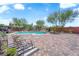 Spacious backyard featuring a refreshing pool, decorative fountain, and ample patio space at 9906 Stiges St, Las Vegas, NV 89178