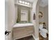 Well-lit half bath featuring a modern vanity, decorative mirror, and stylish fixtures at 9906 Stiges St, Las Vegas, NV 89178